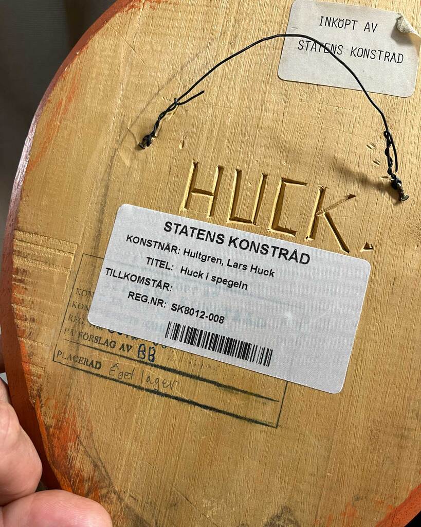Reverse view of Lars Huck's artwork Huck i spegeln showing accession labels and collection records.